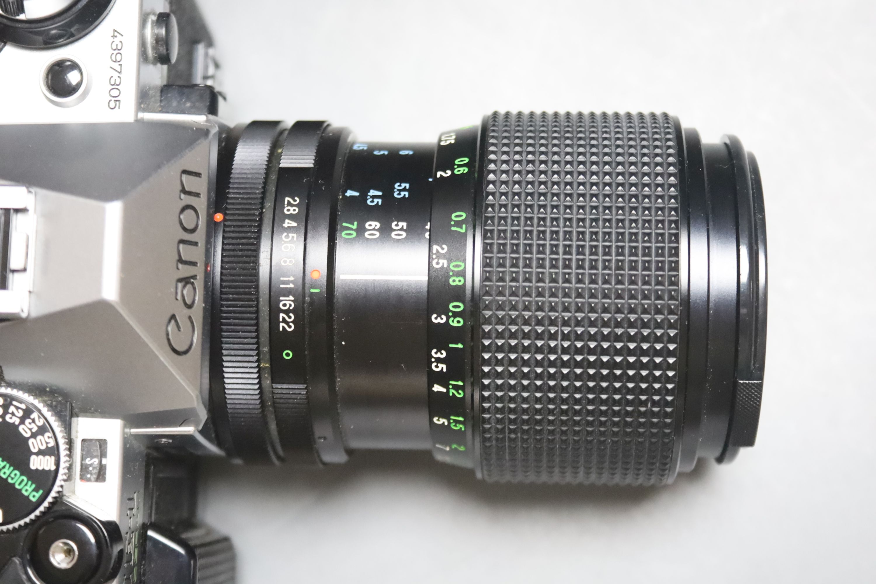 A Canon AE-1 camera serial number 4397305 with a Vivitar macro focusing lens, together with a Paillard Rolex camera